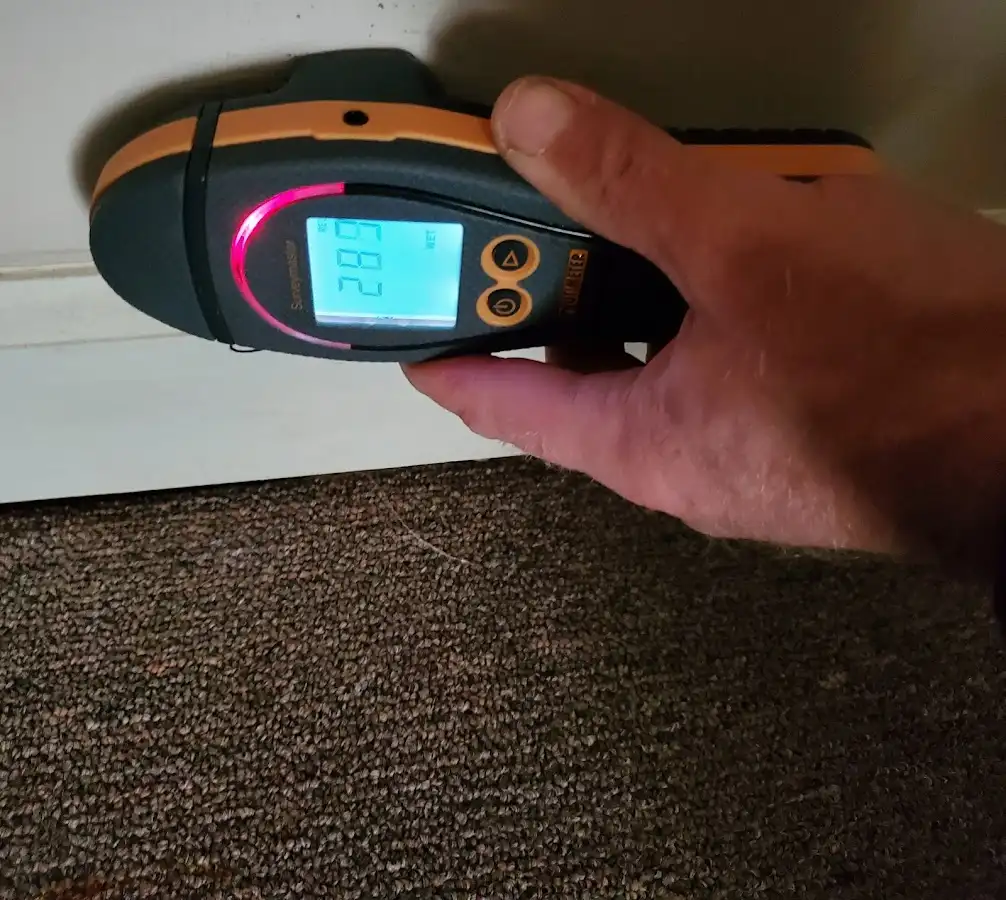 Moisture detection at baseboard during Storm Damage Restoration in Youngsville